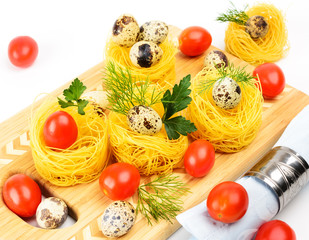 Pasta nests with cherry tomatoes and quail eggs.
