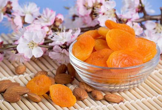 Dried apricots with almonds and blossoming branch