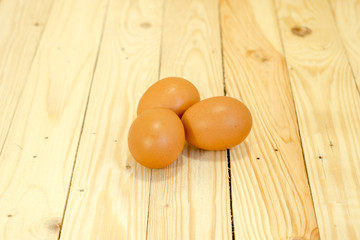 Three eggs on the wooden floor