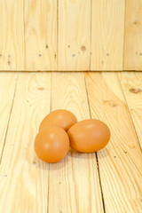Three eggs on the wooden floor