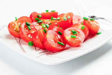 Cherry tomatoes decorated with green onions.