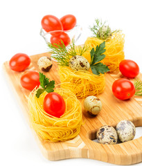 Pasta nests with cherry tomatoes and quail eggs.