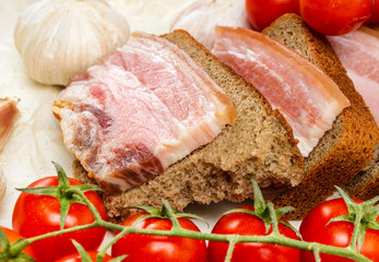 Of salted bacon sandwiches on rye bread.