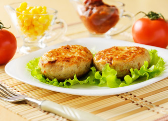 Meat patties on a white plate.