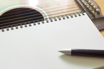 Notebook and pen on guitar
