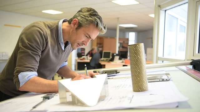 Industrial designer working on project in office
