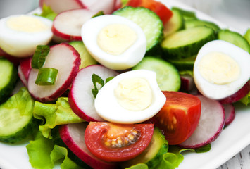 Spring salad with eggs, cucumbers and radish