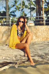 Fashion portrait of sexy woman posing on the beach