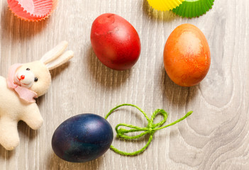 easter concept with colorful edible eggs and bunny toy