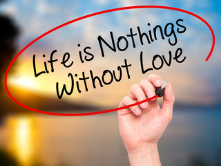 Man Hand writing Life is Nothings Without Love with black marker