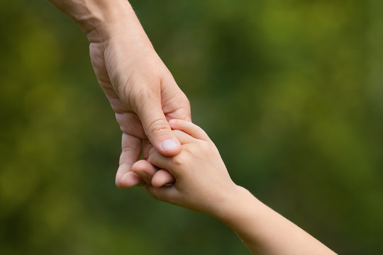 mother holding a hand of child