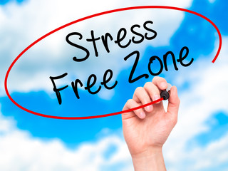 Man Hand writing Stress Free Zone with black marker on visual sc
