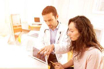 Doctor using tablet to inform patient