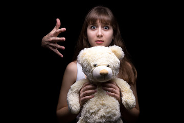 Scared teenage girl with toy