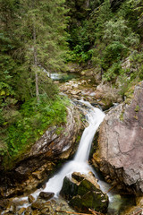 Fototapeta na wymiar Waterfall with stones in forest, Sea Eye, Zakopane