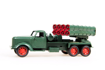 Toy military truck on a white background, a miniature model of the system 