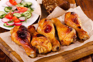 Chicken legs on a wooden board