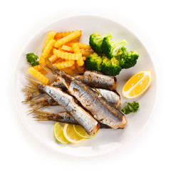 Fried herrings, chips and vegetables