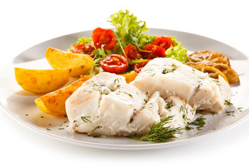 Fish dish -  boiled fish fillet, baked potatoes and vegetables 