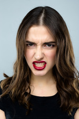 Headshot of a young and angry woman