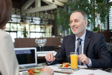 Skillful two managers on meeting in restaurant