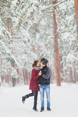 Fototapeta na wymiar Happy Young Couple in Winter Park having fun.Family Outdoors. love, valentine day