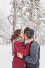 Happy Young Couple in Winter Park having fun.Family Outdoors. love, valentine day