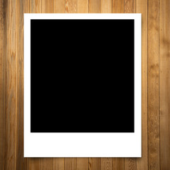 blank photo frame on brown wood plank background