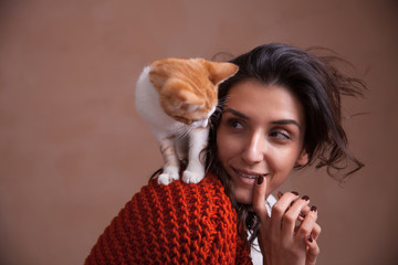 Little kitten on woman shoulder