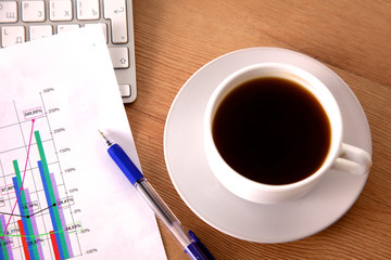 Office table with blank notepad and laptop 