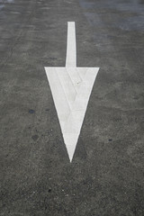 Arrow sign on texture road.
