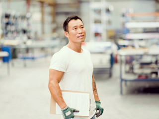 Asian worker in production plant on the factory floor