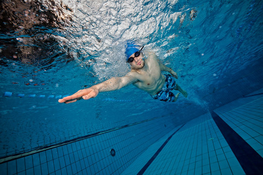 Young man swimming in pool