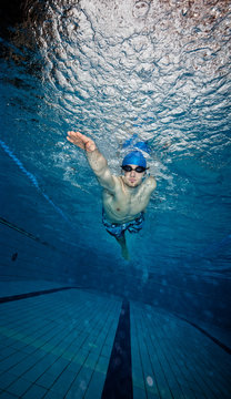 Young man swimming in pool