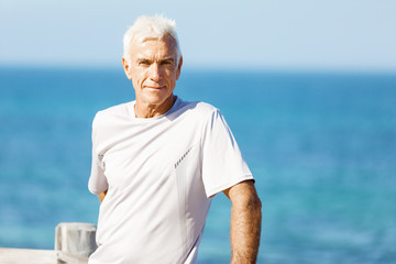 Fototapeta na wymiar Man standing on beach in sports wear