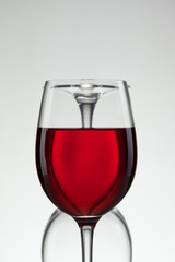 Glass of wine and bottle on white with copy space