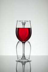 Glass of wine and bottle on white with copy space