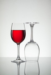 Glass of wine and bottle on white with copy space