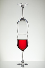 Glass of wine and bottle on white with copy space