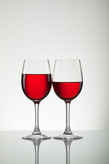 Glass of wine and bottle on white with copy space