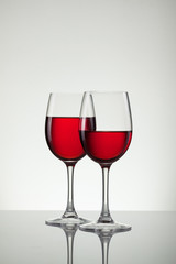 Glass of wine and bottle on white with copy space