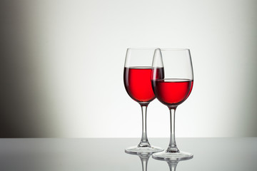 Glass of wine and bottle on white with copy space