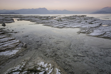 Long exposure during the warm light of an incredible sunset on the Garda lake in Sirmione