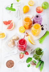 Smoothies, juices, beverages, drinks variety with fresh fruits and berries on a white wooden background