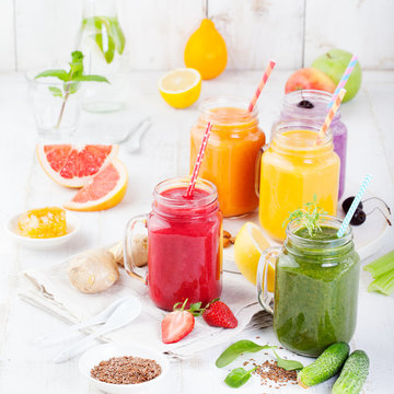 Smoothies, juices, beverages, drinks variety with fresh fruits and berries on a white wooden background