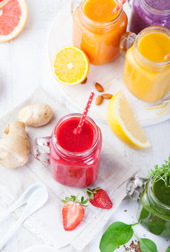 Smoothies, juices, beverages, drinks variety with fresh fruits and berries on a white wooden background