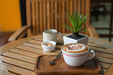 Hot Coffee in white cup on wooden table