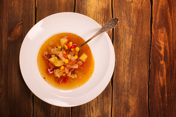 Vegetable spanish soup in white plate. Top view. Toned image