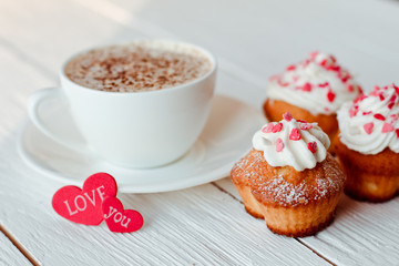 Beautiful coffee Cup with heart cupcake on white wooden background