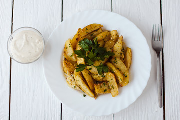 beautiful roasted potatoes with herbs and spices on a white plate